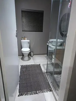 a bathroom with a shower and a toilet and a sink at J & M Elegant escape 2 in Centurion