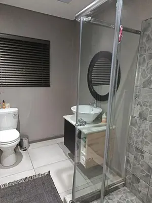 a bathroom with a shower and a toilet and a sink at J & M Elegant escape 2 in Centurion