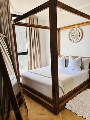a bedroom with a canopy bed with white sheets at Thango Executives Gallileo Ellipse in Midrand