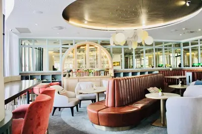 a restaurant with a couch and tables and chairs at Thango Executives Gallileo Ellipse in Midrand