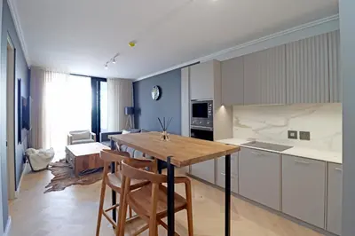 a kitchen with a table and chairs in a room at Thango Executives Gallileo Ellipse in Midrand