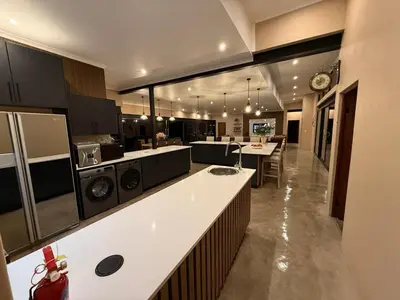 a large kitchen with a counter and a dining room at Blessed Lodge at Ingilozi Mabalingwe in Warmbaths