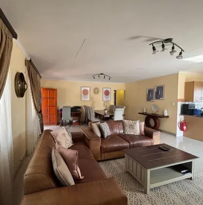 a living room with a couch and a table at Divine apartments in Polokwane