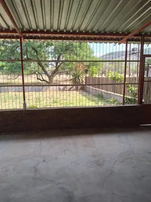 an empty room with a large window with a fence at The Pasture Loft in Mokopane