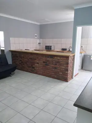 a kitchen with a brick counter in a room at The Pasture Loft in Mokopane