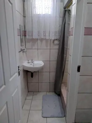 a small bathroom with a sink and a mirror at The Pasture Loft in Mokopane