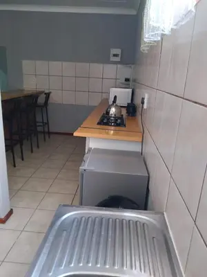 a small kitchen with a stove and a counter at The Pasture Loft in Mokopane