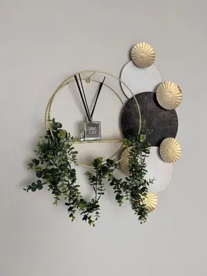 a wreath with lights and a clock on a wall at Sunset Sucasa in Midrand