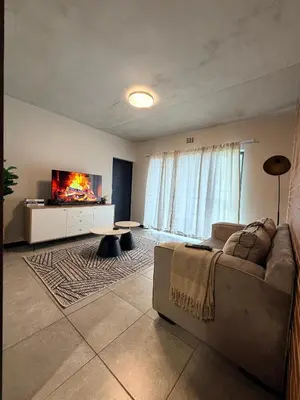 a living room with a couch and a fireplace at Sunset Sucasa in Midrand