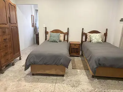 a bedroom with two beds and a dresser at Elements Private Golf Reserve 123 in Warmbaths