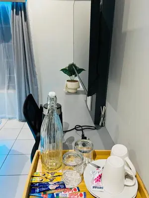 a table with a tray with a glass jug on it at The Wired Nest in Ellisras