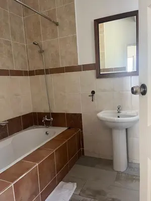 a bathroom with a bath tub and a sink at 165 Neptune Waterkloof Pretoria in Pretoria