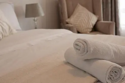 a hotel room with towels on a bed at 165 Neptune Waterkloof Pretoria in Pretoria