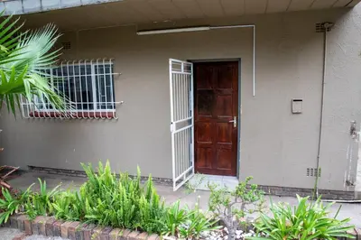 a house with a brown door and some plants at Serenity on Geelhaak in Kempton Park