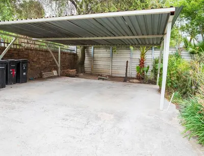 an empty parking lot with awning over it at Serenity on Geelhaak in Kempton Park
