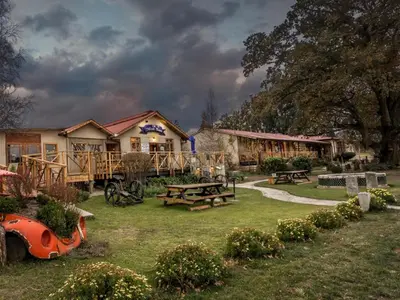 a house with a picnic table in the yard at John Jack Inn Accommodation in Lake Chrissie