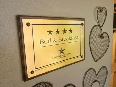 a sign that reads bed and breakfast on a wall at John Jack Inn Accommodation in Lake Chrissie