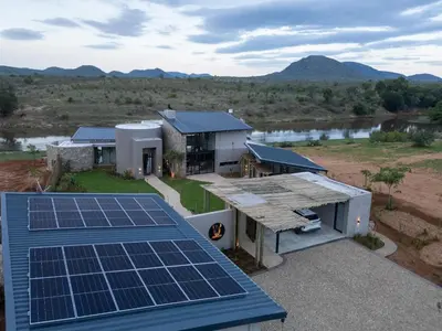 an aerial view of a house with solar panels on the roof at Izakithi River Villa in Malelane