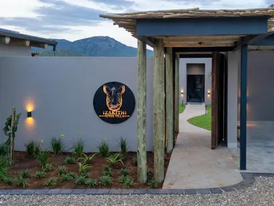 a sign on the side of a building with a cow on it at Izakithi River Villa in Malelane