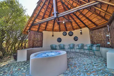 a conference room with chairs and a wooden roof at Doornkop Luxury 8 Sleeper with Private Pool and Boma in Carolina