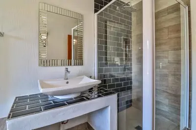 a bathroom with a sink and a mirror at Doornkop Luxury 8 Sleeper with Private Pool and Boma in Carolina