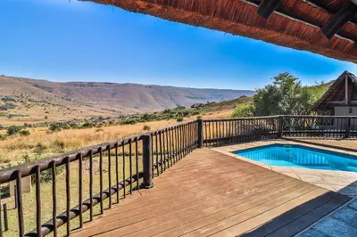 a wooden deck with a swimming pool on top of a house at Doornkop Luxury 8 Sleeper with Private Pool and Boma in Carolina