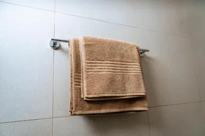 a towel hanging on a towel rack in a bathroom at Fully Equipped Modern 2-Bedroom in Midrand