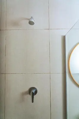 a bathroom with a door with a handle and a mirror at Fully Equipped Modern 2-Bedroom in Midrand