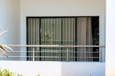 a balcony with a table and a potted plant at Fully Equipped Modern 2-Bedroom in Midrand