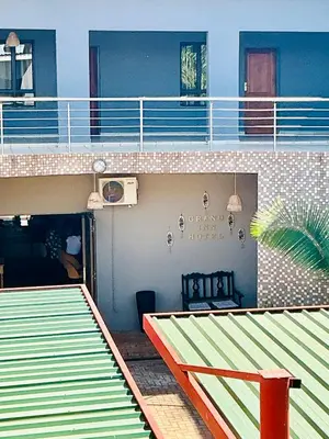 a balcony of a house with a patio at Grand Inn Hotel-Venda in Thohoyandou