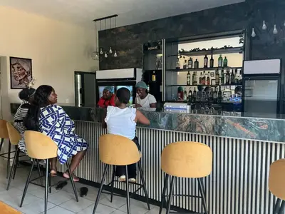 a group of people sitting at a bar at Grand Inn Hotel-Venda in Thohoyandou