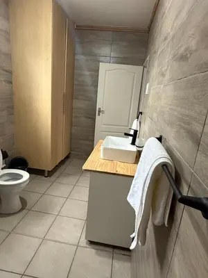 a bathroom with a sink and a toilet at Grand Inn Hotel-Venda in Thohoyandou