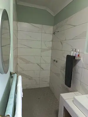 a bathroom with a shower and a sink at Villa De Lyden in Lydenburg