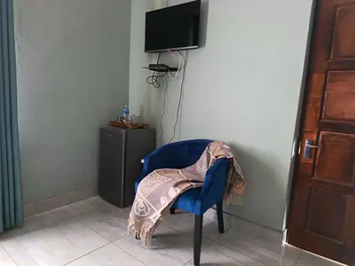 a blue chair with a jacket on it in a room at Villa De Lyden in Lydenburg