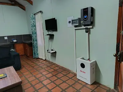 a room with a living room with a speaker on the wall at Villa De Lyden in Lydenburg