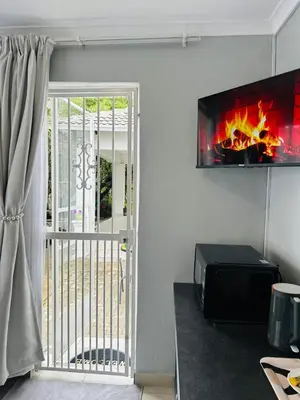 a view of a living room with a fireplace at Rugare Haven 2 in Kempton Park