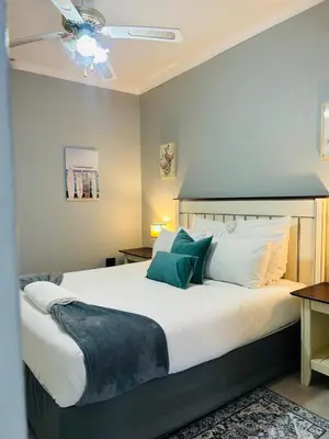 a bedroom with a large bed with a ceiling at Rugare Haven 2 in Kempton Park