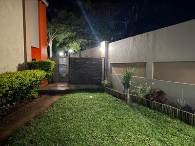 a backyard at night with a fence and grass at Mona Lisa No5 in Polokwane