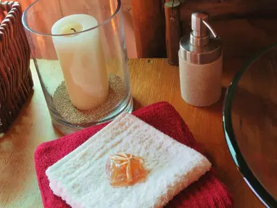a glass vase with a candle and a red towel at Iphofolo Lodge & Tented Camp in Vivo
