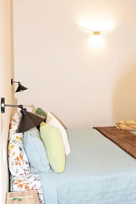 a bed with pillows on it in a room at Pecan and Lime Inn The First Den in Pretoria