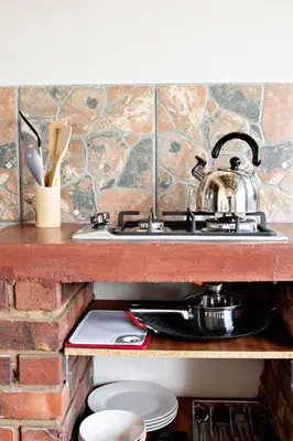 a kitchen sink with a pot on top of it at Pecan and Lime Inn The First Den in Pretoria