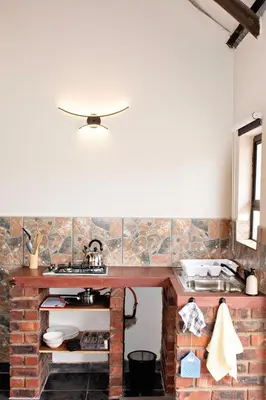 a kitchen with a brick counter and a sink at Pecan and Lime Inn The First Den in Pretoria