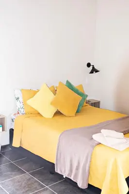 a bedroom with a bed with yellow and green pillows at Pecan and Lime Inn The Second Den in Welbekend