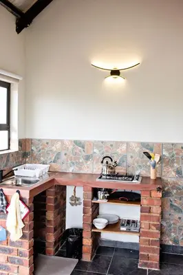 a kitchen with a brick counter and a sink at Pecan and Lime Inn The Third Den in Pretoria