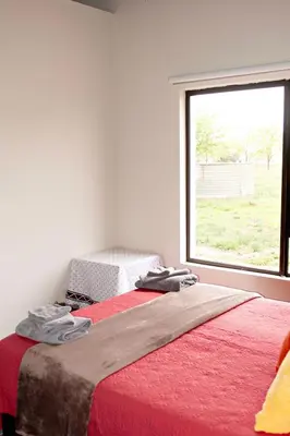 a bedroom with a bed with a large window at Pecan and Lime Inn The Third Den in Pretoria