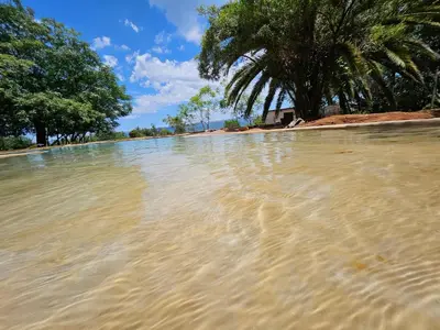 a large pool of water on a beach with trees at Seid Manor Wellness and Healing Retreat in Hartbeespoort
