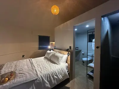 a bedroom with a bed with a light above it at Seid Manor Wellness and Healing Retreat in Hartbeespoort