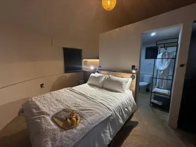 a bedroom with a bed with a tray with stuffed animals on it at Seid Manor Wellness and Healing Retreat in Hartbeespoort