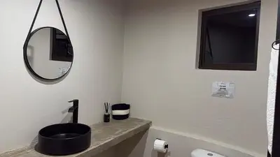a bathroom with a black sink and a mirror at Seid Manor Wellness and Healing Retreat in Hartbeespoort