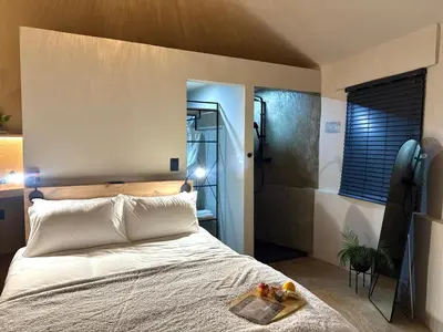a bedroom with a bed with a tray of fruit on it at Seid Manor Wellness and Healing Retreat in Hartbeespoort